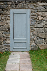 one old and grey door in the wall