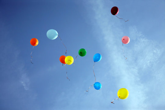 colored balloons flying in the blue sky
