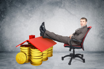 Businessman sitting on chair with coins and roof