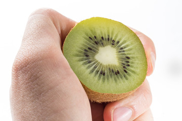 fresh isolated kiwi and human hand