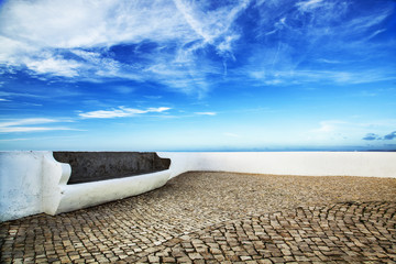 Bench over textured sky, Santa Cruz, Portugal