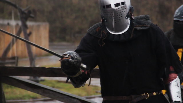 Brave warriors starting sword fight, reenactment of medieval knights tournament