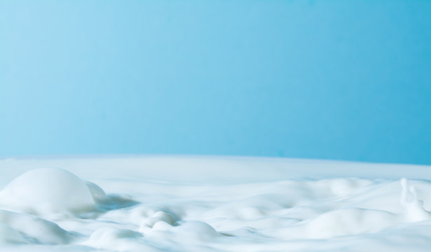 splash of milk  on a light blue background