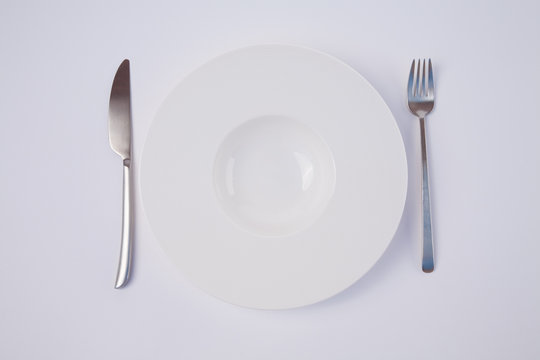 empty white dish and cutlery