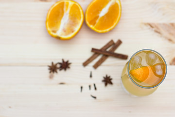 Lemonade with orange and spices on the table