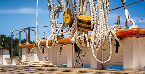 Nautical ropes and rigging on the deck of a wooden sailboat
