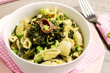 delicious orecchiette with broccoli rabe over pink plate