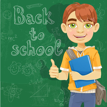 Banner Back to school - Teenage boy with a textbook near blackbo