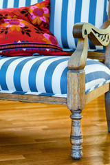 Blue and white striped upholstered chair with pillow