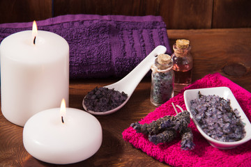 Fototapeta na wymiar Spa candle and lavender flower bath salts massage oil