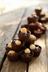 Composition of different chocolate candies on wooden background, close up