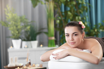 Obraz na płótnie Canvas Young woman ready for spa massage at beauty spa