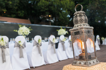Vintage lantern lighting in front of party background.