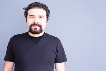 Man with Beard and Curly Hair Wearing Dark T-Shirt