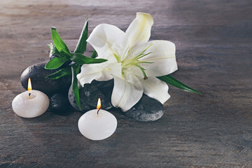 Spa still life with beautiful flower and candlelight on wooden background