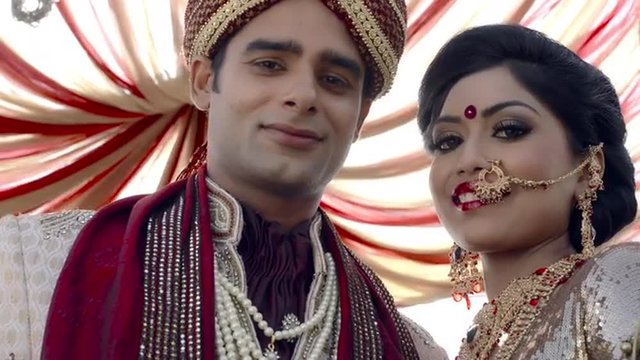 Shot of Indian bride and groom in traditional wedding dress under a mandap