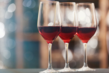 Glasses with red wine on blurred background