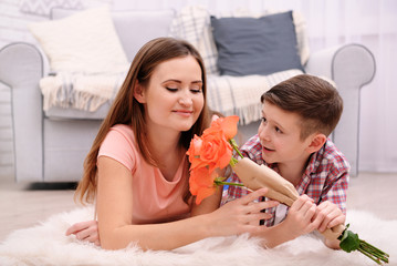 Son giving roses to his mother