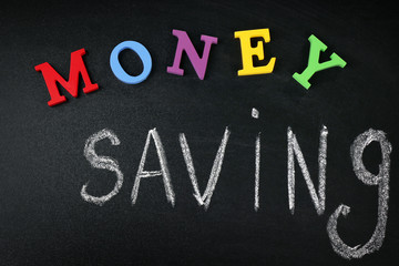 Money saving concept on a blackboard background