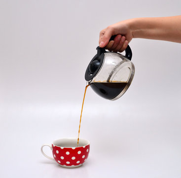 Woman Hand Pouring Coffee In A Mug