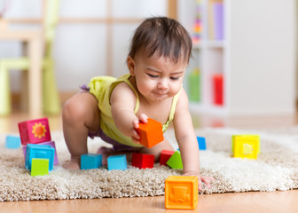 baby toddler playing  wooden toys at home or nursery - obrazy, fototapety, plakaty