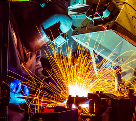 Empoyee welding Industrial automotive part in factory
