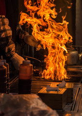 chef grilling bbq with flame of burning in restaurant