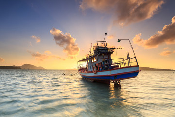 Fishing boat stand at sunrise beach in Phuket