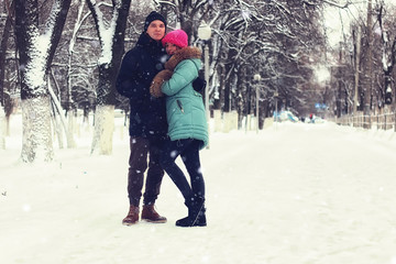 couple of young lovers walk in winter