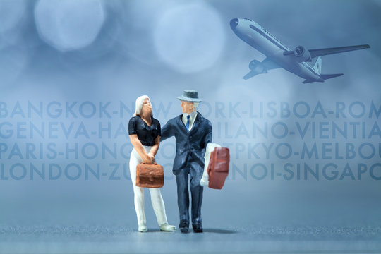 Miniature people - a businessman and businesswoman waiting in the airport lobby