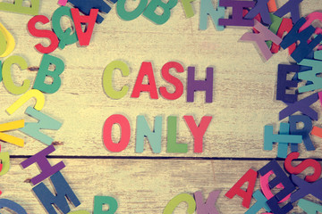 cash only word block concept photo on plank wood