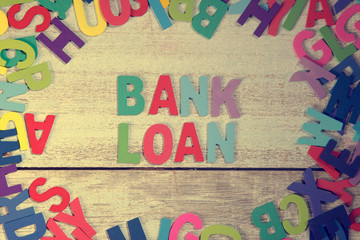 bank loan word block concept photo on plank wood