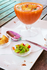 Delicious gazpacho on wooden table.