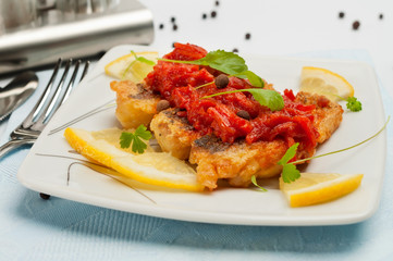 Pieces of fried fish with vegetable marinade.