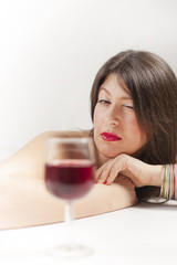 Young woman with glass of wine. Studio. White.