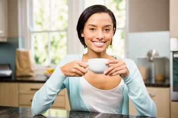 Smiling brunette holding mug