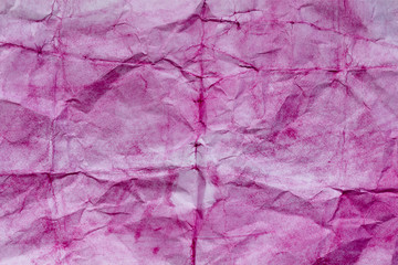 Crumpled pink paper. Painted watercolors. Closeup.