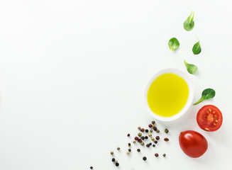 Healthy food background with olive oil,  cornsalad and colorful spices on white backdrop.Detox and diet concept. 