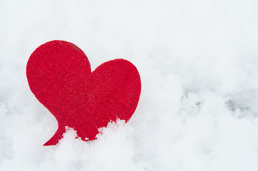 Fototapeta premium red heart on ice wet snow, outdoors image