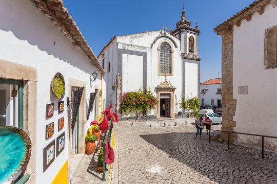 Obidos, Portugal. Sao Pedro church and a souvenir shop. Obidos is a medieval town inside walls, and very popular among tourists.