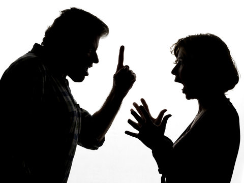 Silhouette of a couple in a heated argument