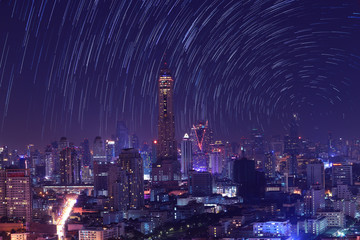 The night sky , the stars and the Tallest building in the city.