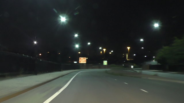 Car windscreen view of the highway at night in the city