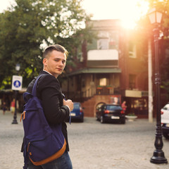 Portrait of young man with a backpack on his back