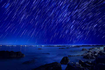 The motion beautiful star trail image during the night in the se