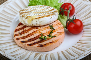 Fototapeta na wymiar Grilled fish cutlet and camembert cheese