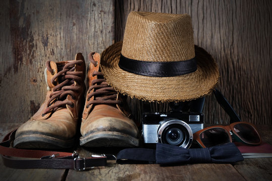 Shoe hat and accessories travel set on a wooden background