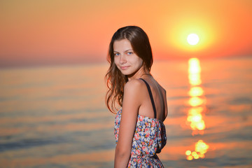 Fototapeta na wymiar young woman in bikini on beach the sunset.