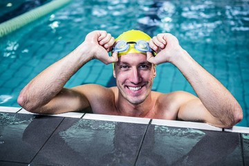 Fit swimmer lean on edge of the swimming pool