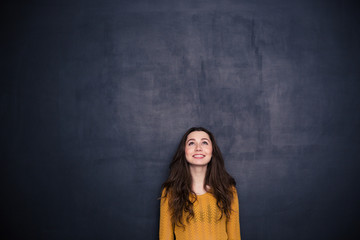 Smiling woman looking up at copyspace